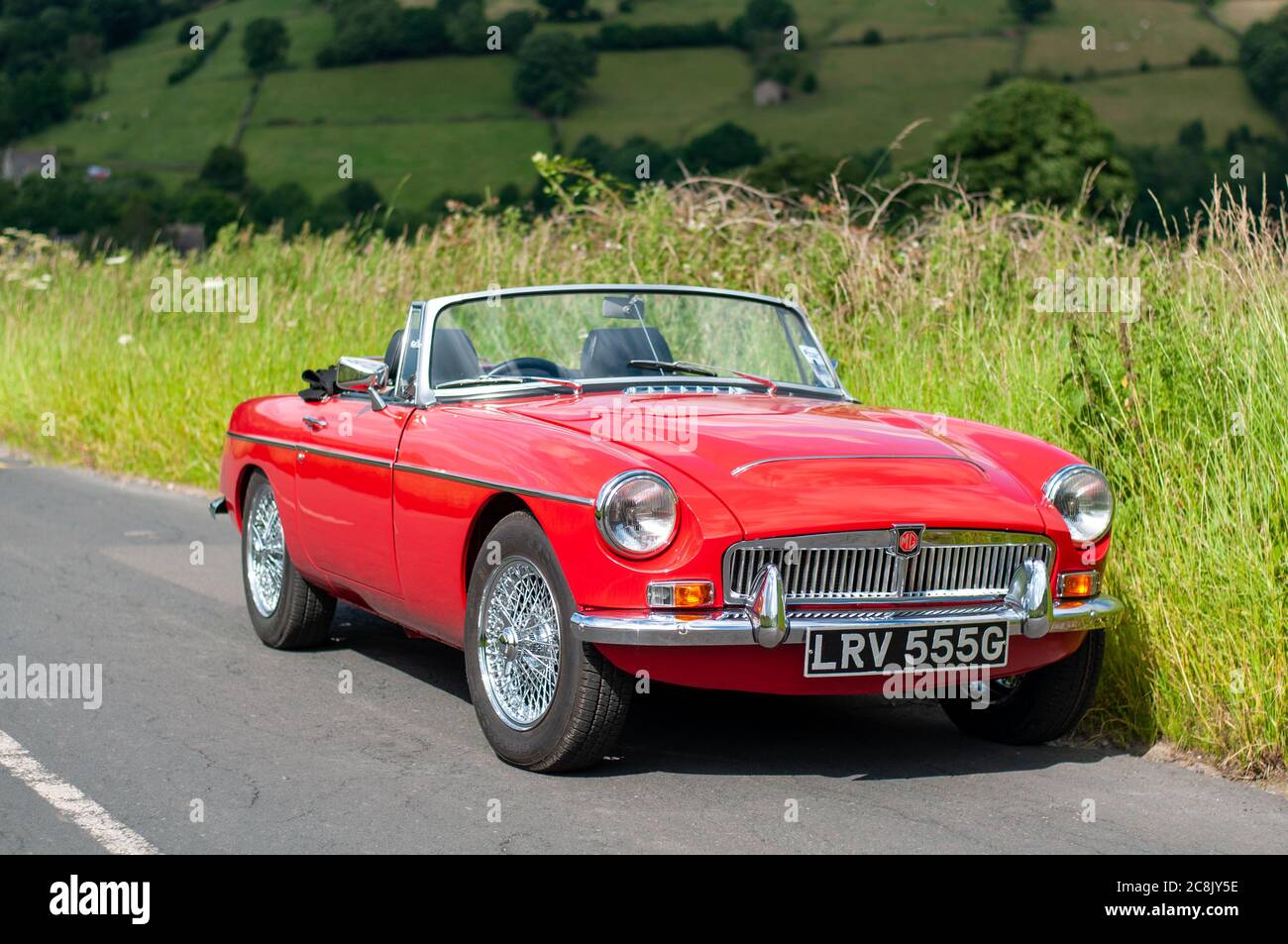 Chrome bumper MGB GT British classic car standing on a country lane in