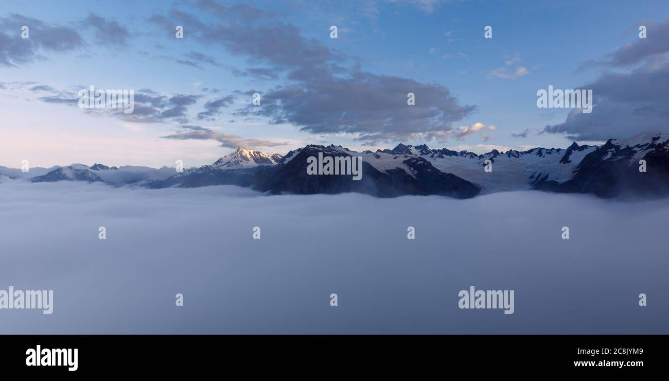 Cloud inversion over the Franz Josef valley with most of Franz Josef Glacier obscured by the clouds after sunset, view from Alex Knob. Stock Photo