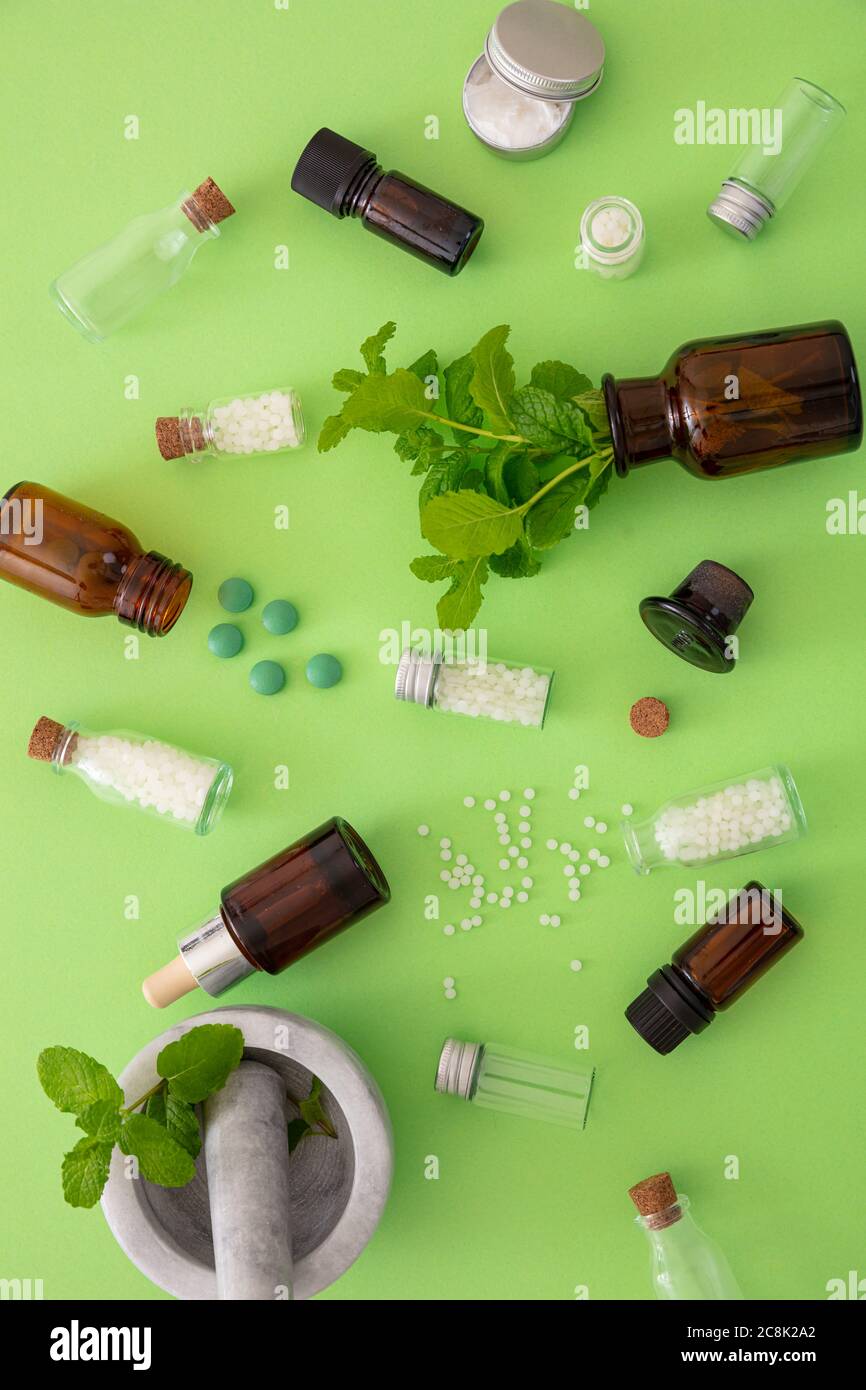 Alternative herbal medicine. Homeopathic globules, fresh mint herb