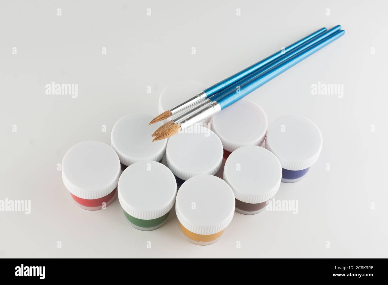 jars of colored paint for creativity on a white background Stock Photo