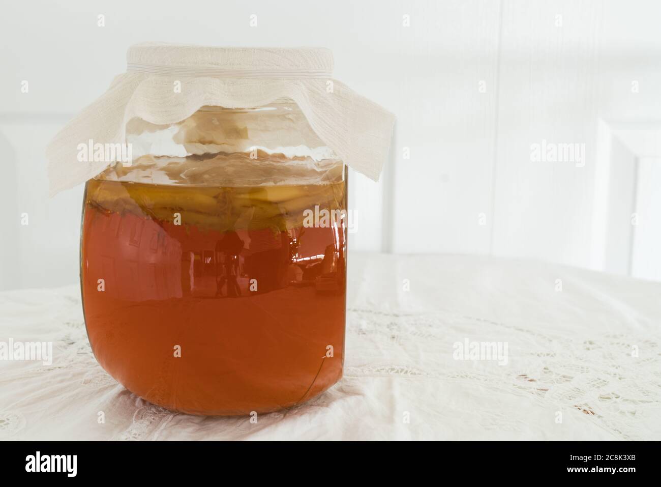 Sweet black tea with kombucha scoby fermenting Stock Photo