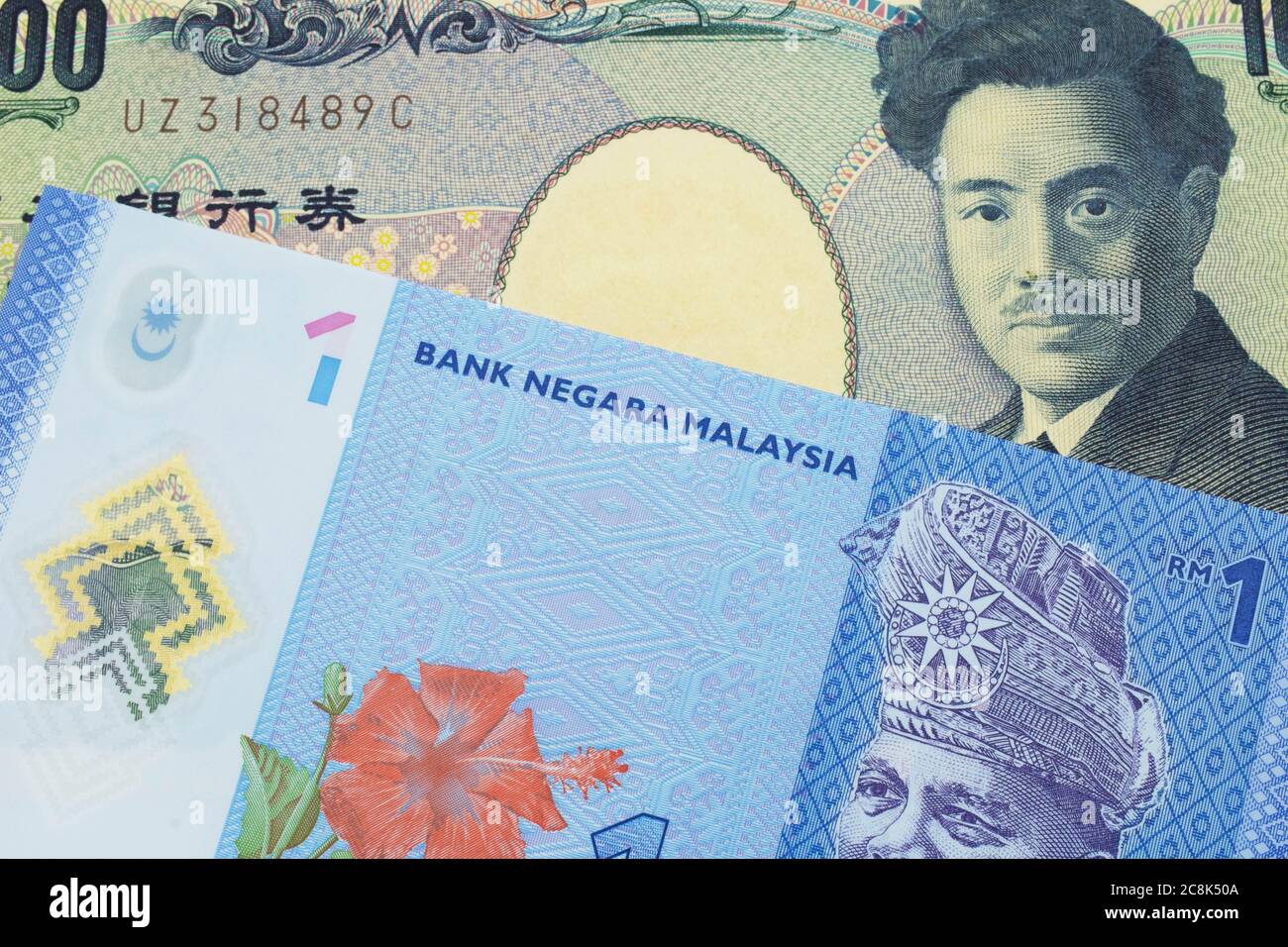 A Macro Image Of A Japanese Thousand Yen Note Paired Up With A Blue Plastic One Ringgit Bank Note From Malaysia Shot Close Up In Macro Stock Photo Alamy