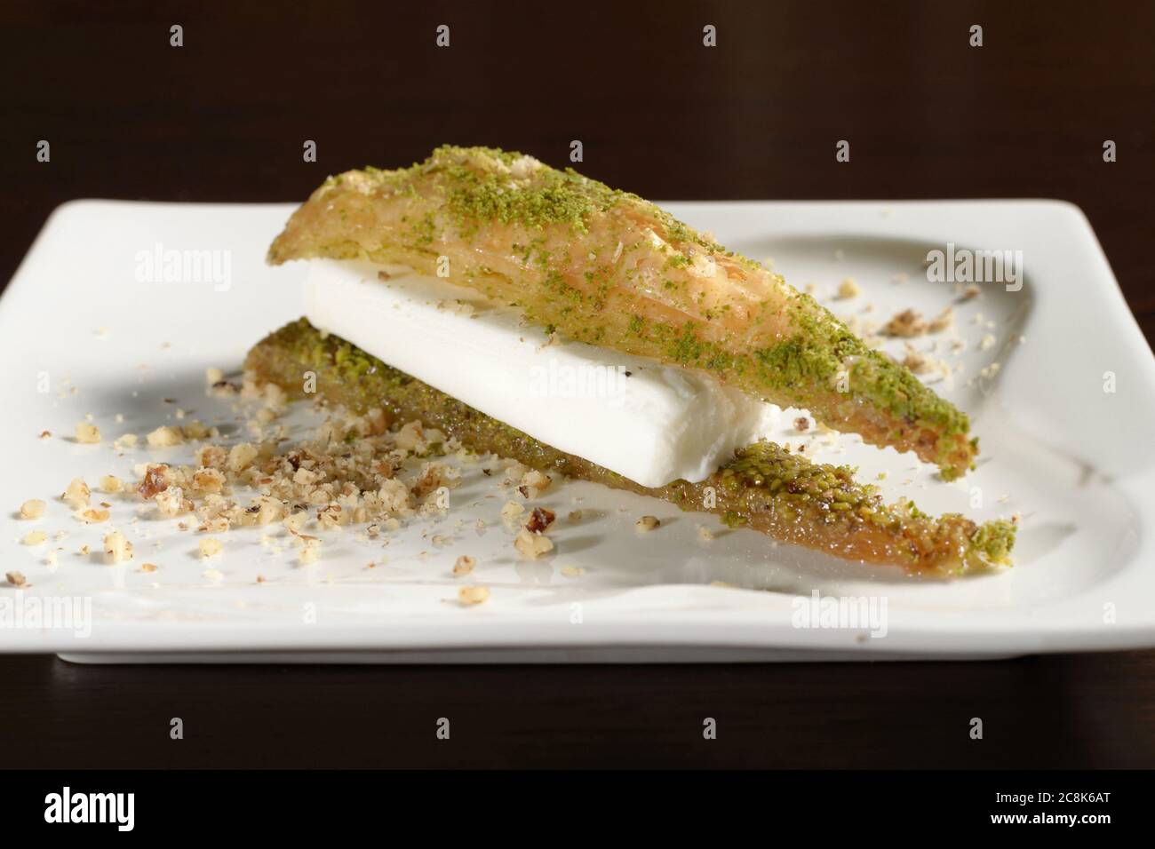 Triangular Turkish baklava with ice cream on a plate close up. Photos for restaurant and cafe menus Stock Photo