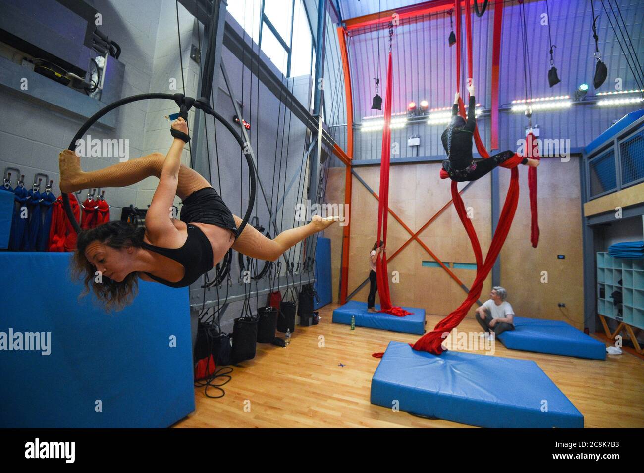Aerialists practice their skills on ribbons and hoops at Flying Fantastic in Southwark, London, as indoor gyms, swimming pools and sports facilities can reopen as part of the latest easing of coronavirus lockdown measures in England. Stock Photo
