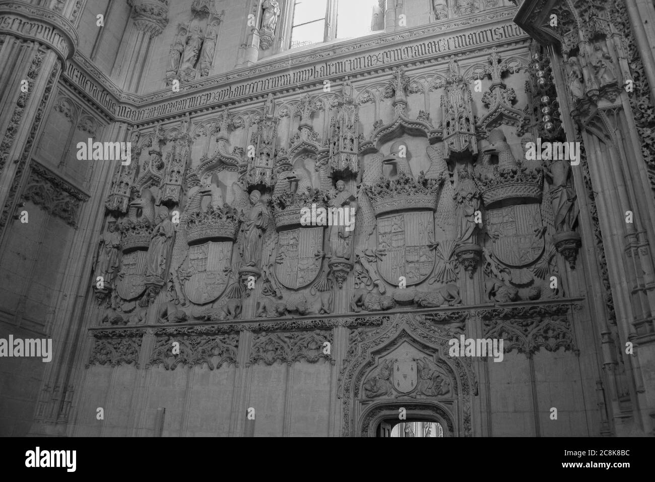 Toledo, Castilla-La Mancha, Spain, Europe. Monastery of San Juan de los Reyes (14771504). Inside, a wall of the church with bas-reliefs depicting coats of arms and saints. Stock Photo