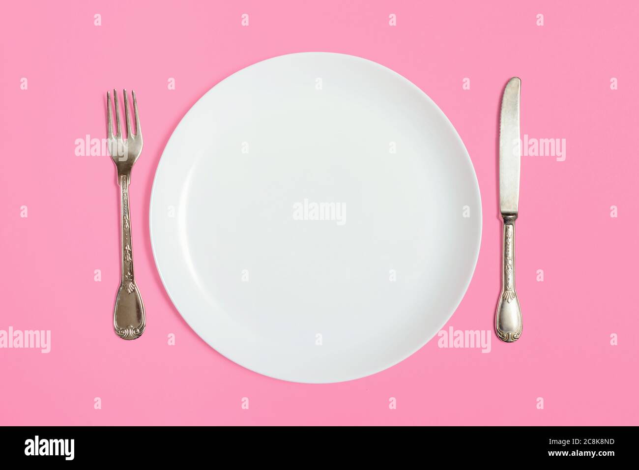 White empty plate with fork and knife Stock Photo