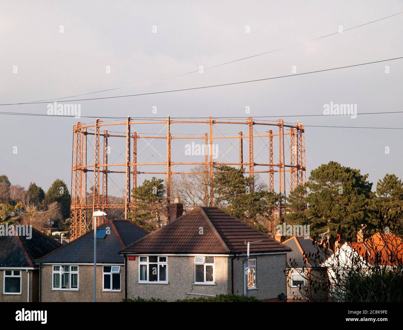 A view of the now demolished cast iron gas holder at Branksome, Poole, England which was built early in the last century showing residential propertie Stock Photo