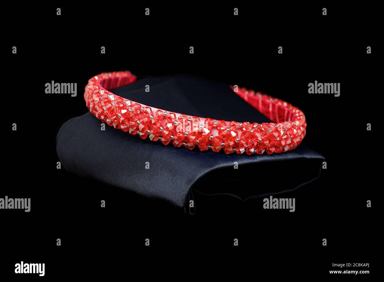 Red ruby tiara gemstones diamonds hair band on black background. Jewelry display isolated concept Stock Photo