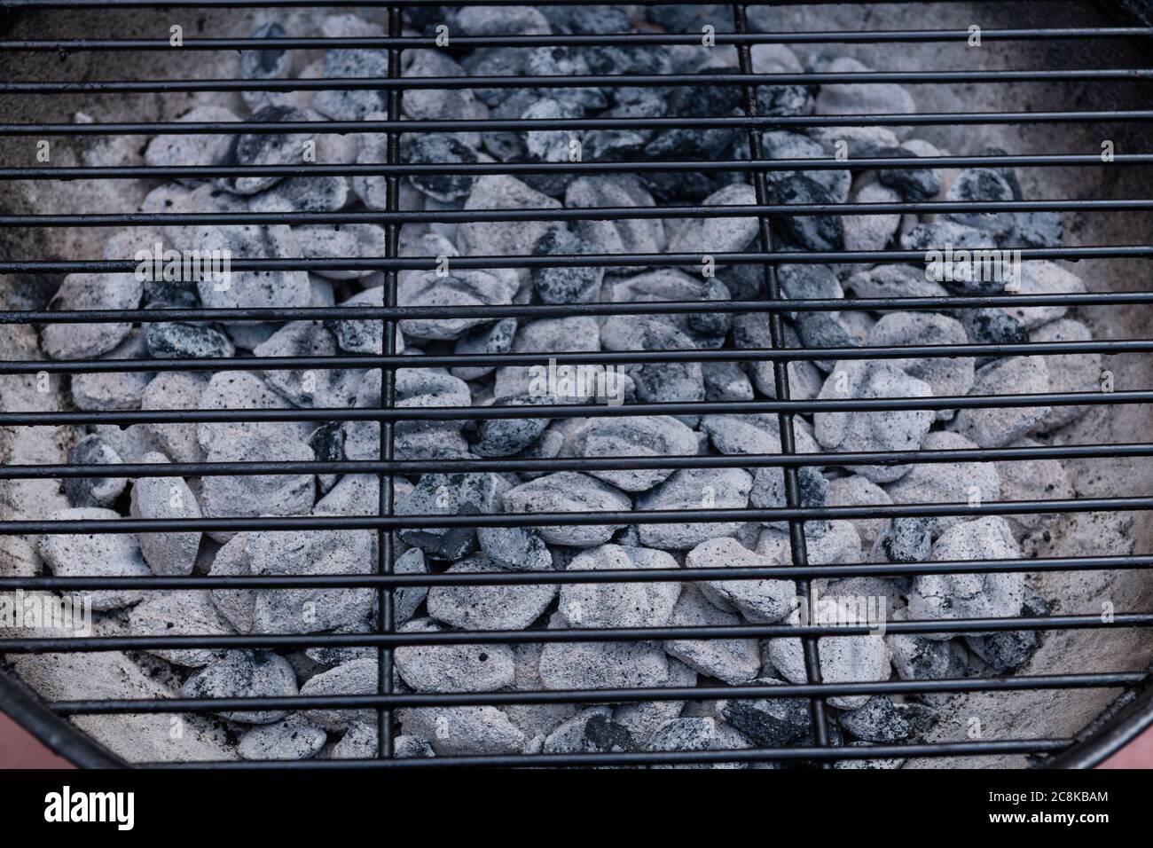 Closeup of BBQ grill pit hot charcoal briquettes, food Background or