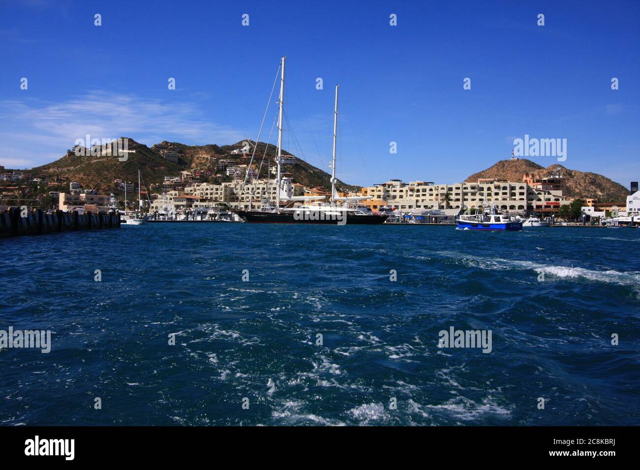 Fun vacation on a cruise ship, at port of call with sailboat. Stock Photo