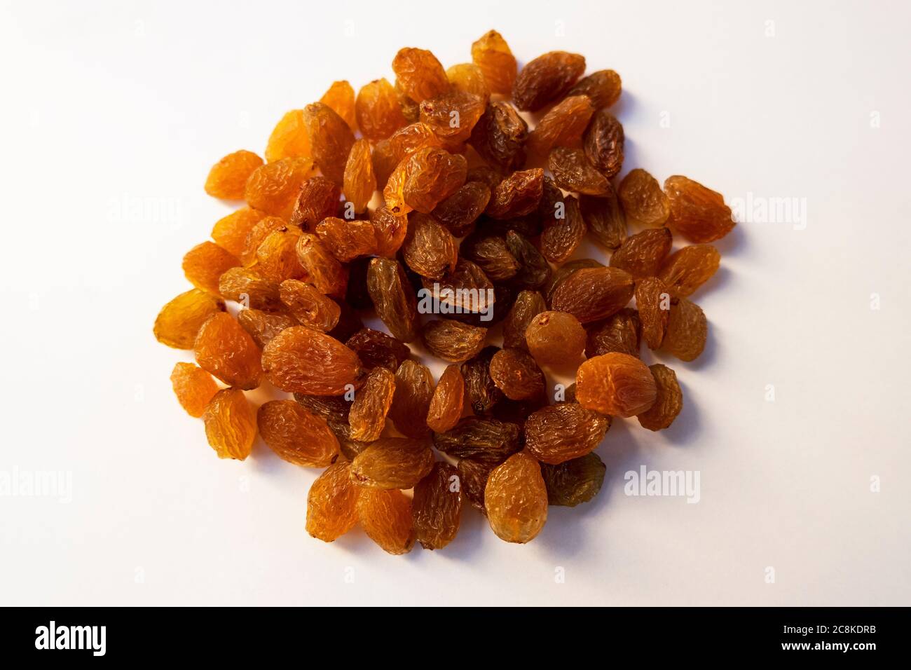 a top shot of dry fruit raisins seedless kishmish on white background ...