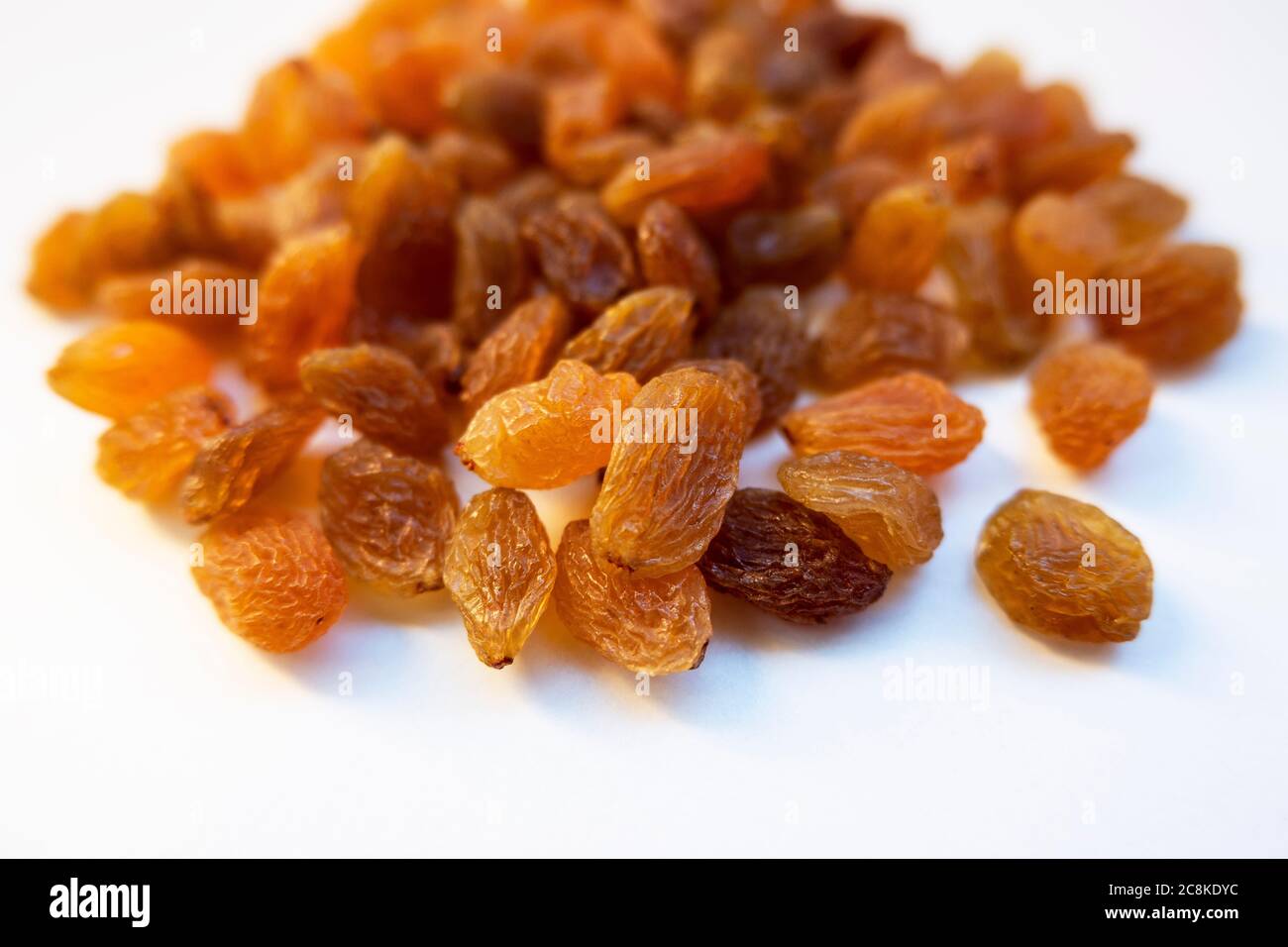 a low angle shot of raisins seedless kishmish on white background Stock
