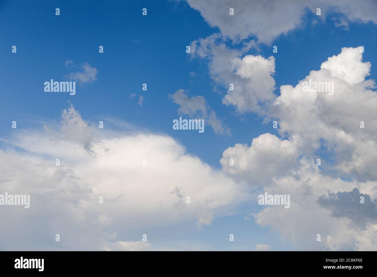 Light blue sky with fluffy white clouds Stock Photo - Alamy