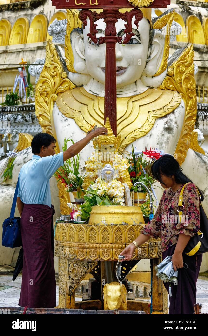 Cleansing and giving thanks at the Shwedagon Pagoda, Yangon, Myanmar Stock Photo