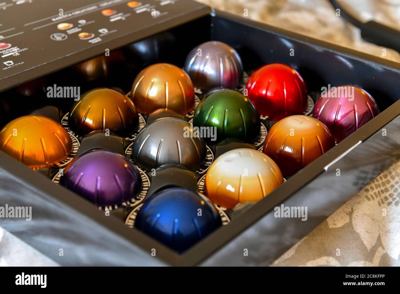 Colorful coffee pods in nice packaged box for espresso and cappuccino maker, near ones purposely blurred Stock Photo