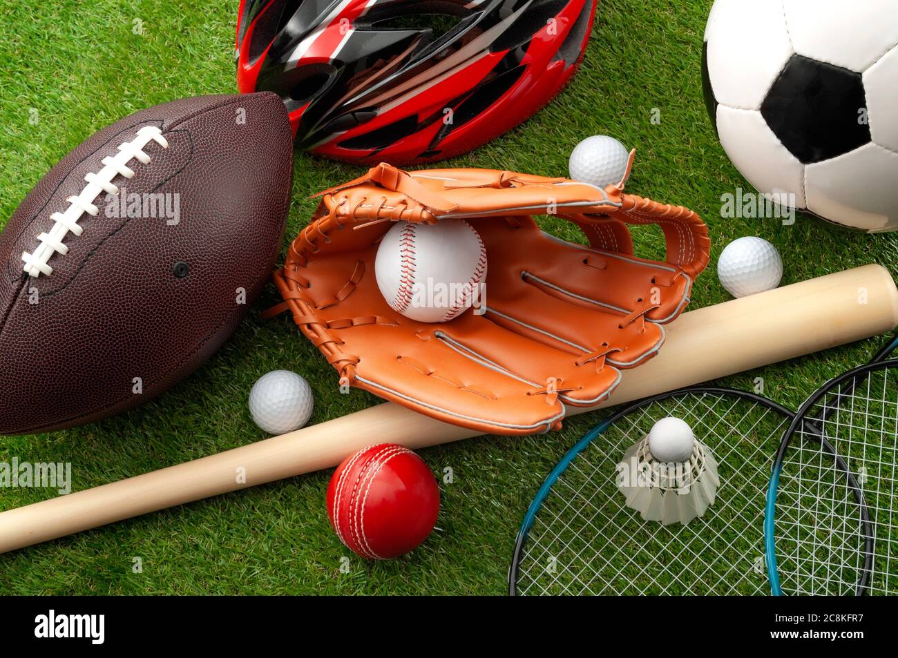Sports shop, youth athletics and team sport competition conceptual idea with various types balls (soccer, baseball, football, golf ball), wooden bat a Stock Photo