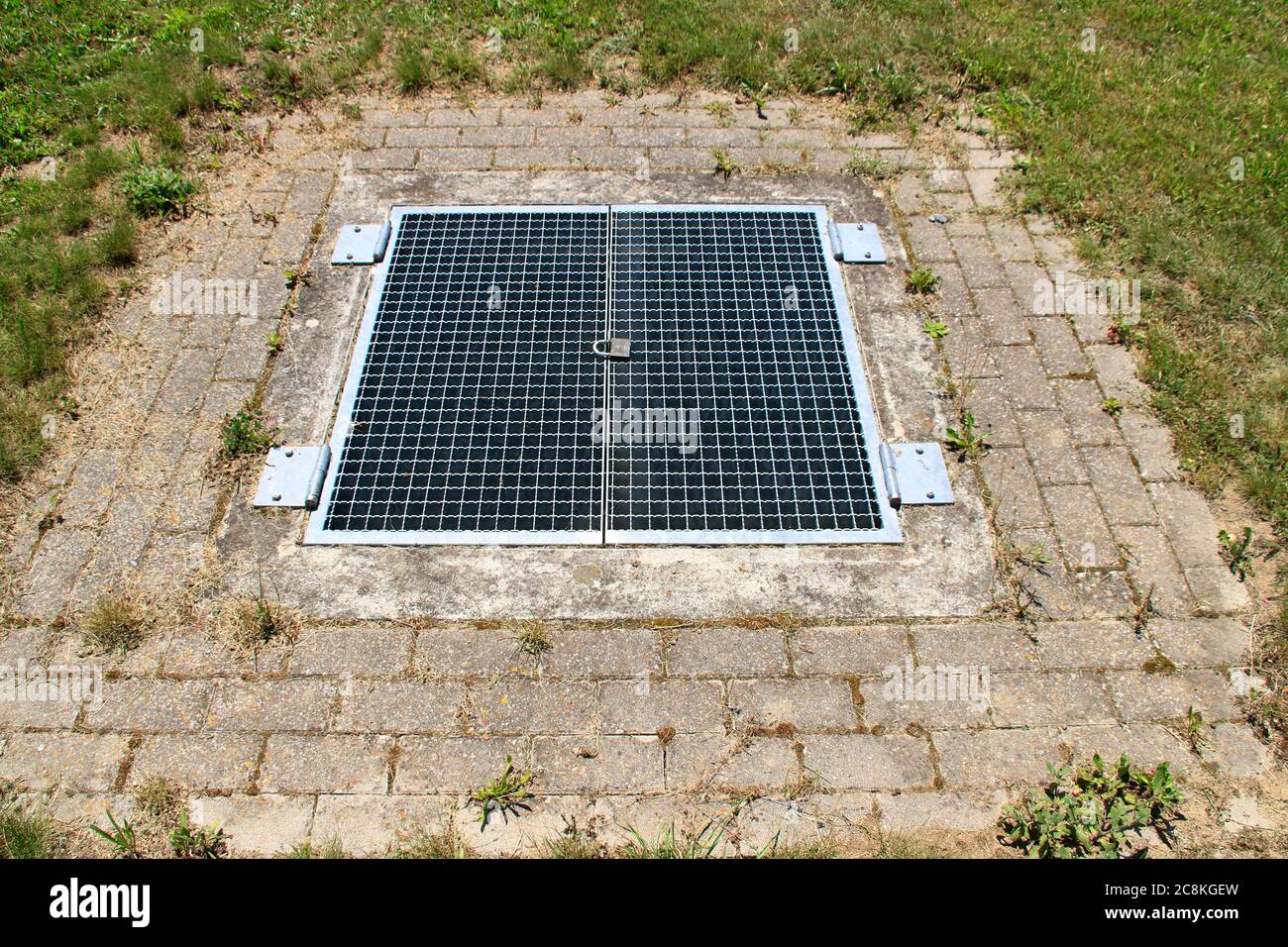 Metal grille for entering a rainwater retention basin was secured with a lock Stock Photo