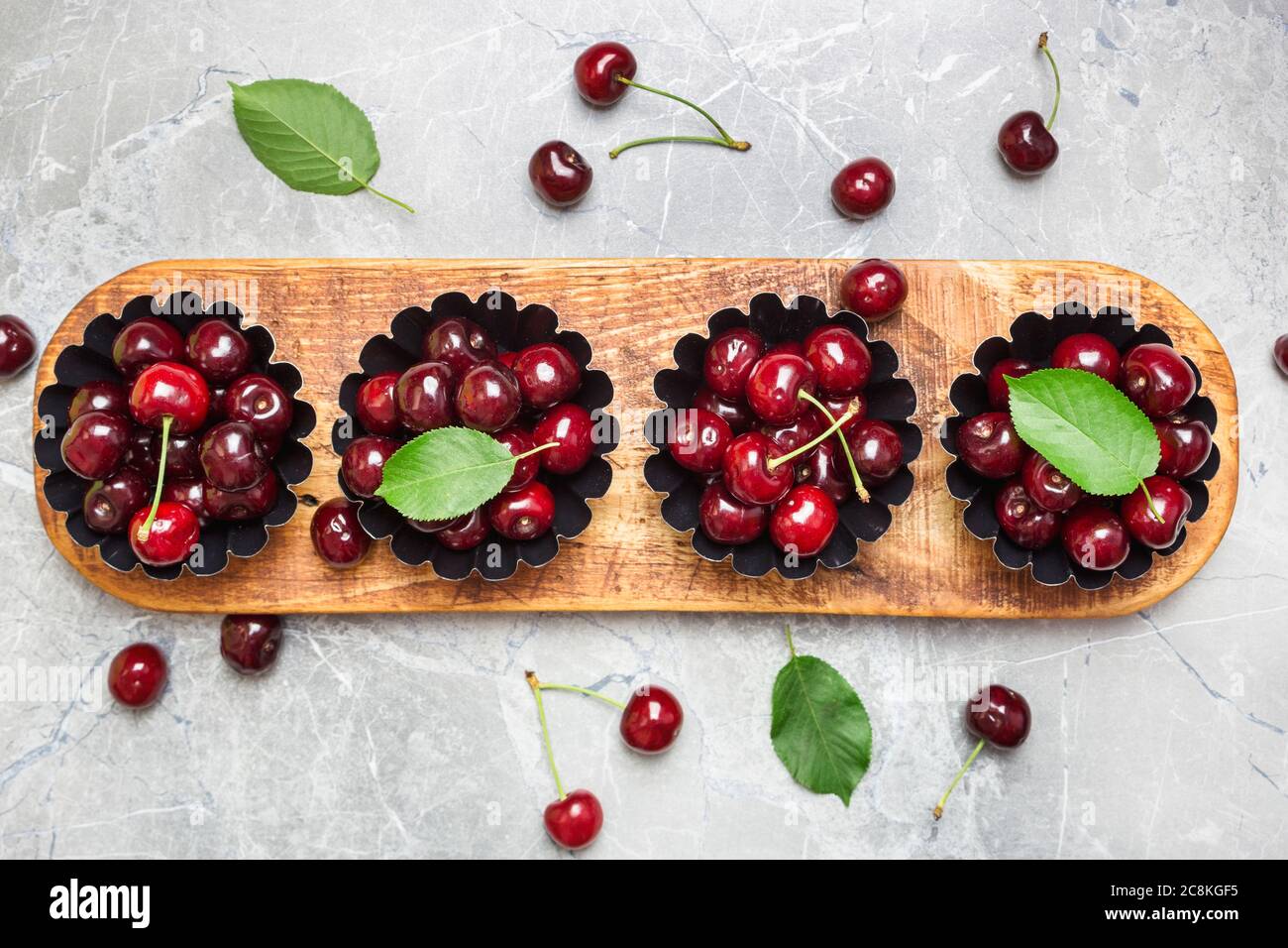 Flat lay composition with sweet cherries on marble table, space for text. Stock Photo