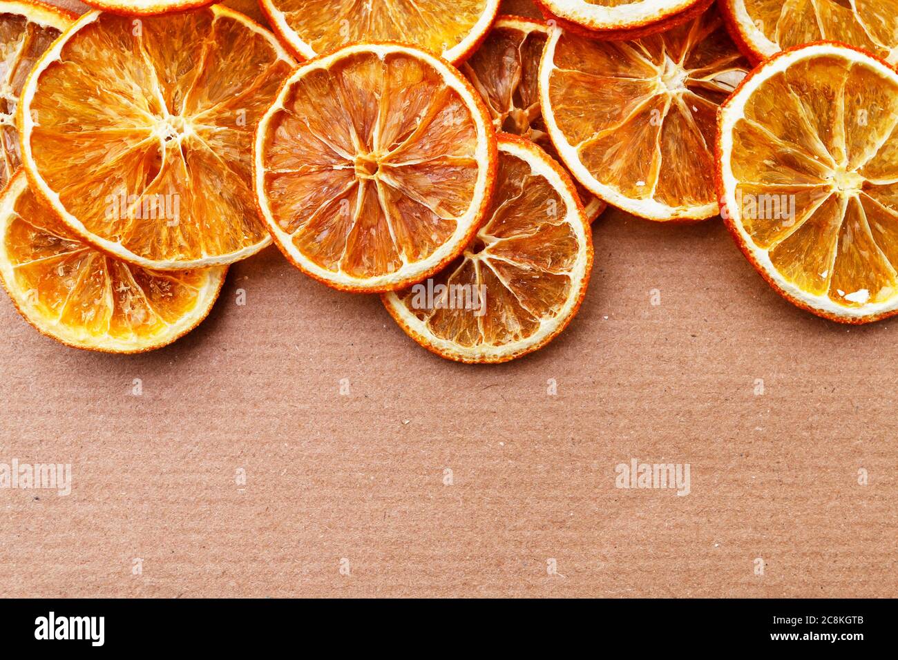 A sliced dry oranges on paper background, copy space. Stock Photo