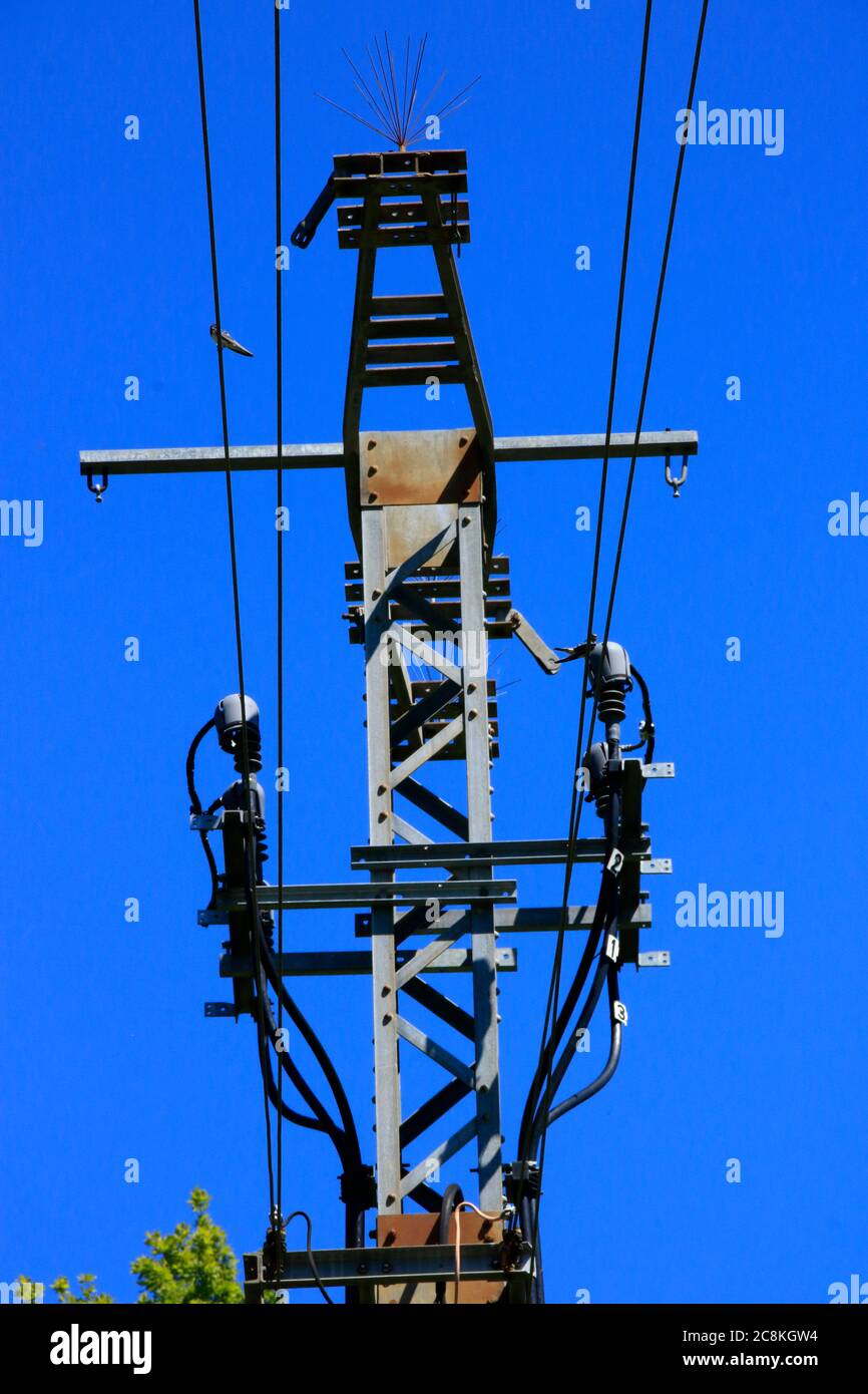 Power pole and power cable in front of a blue sky Stock Photo - Alamy