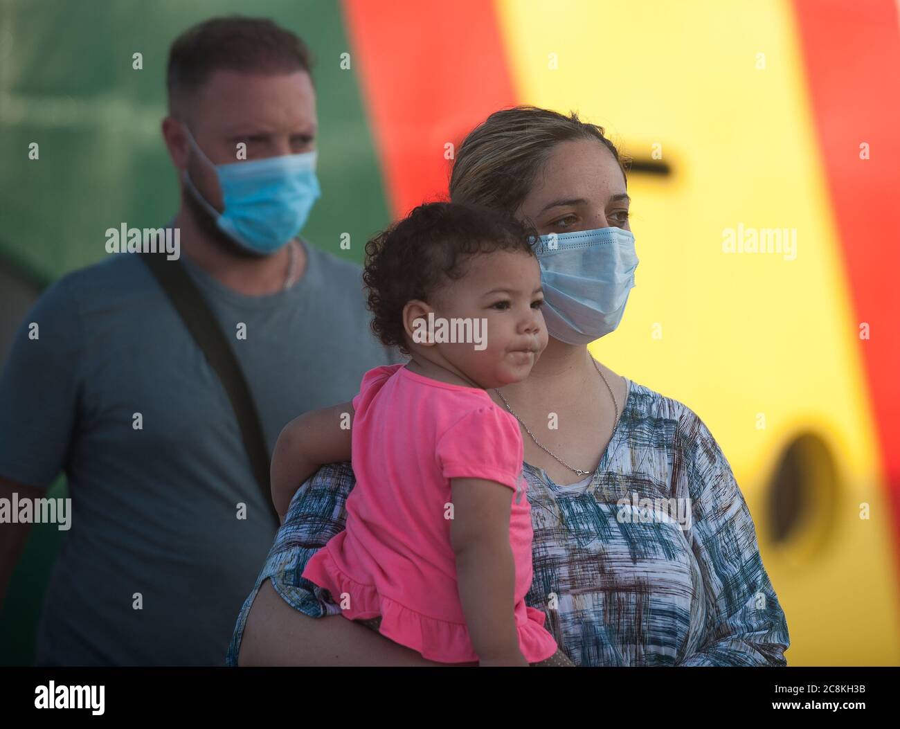 Algerian migrants wearing face masks disembark from a patrol vessel at Malaga port after being intercepted by Spanish Civil Guards authorities on the Mediterranean Sea.A Spanish Civil Guard vessel intercepted around 82 Algerian migrants near Almeria's coast while trying to reach Europe by small boats. During the coronavirus pandemic, the closure of Morocco's border with Spain as a measure to prevent the spread of coronavirus disease has caused a drastic drop in the number of migrants that try to reach the Spanish coasts across Alboran Sea route, while the arrival of migrants to Canary Islands Stock Photo