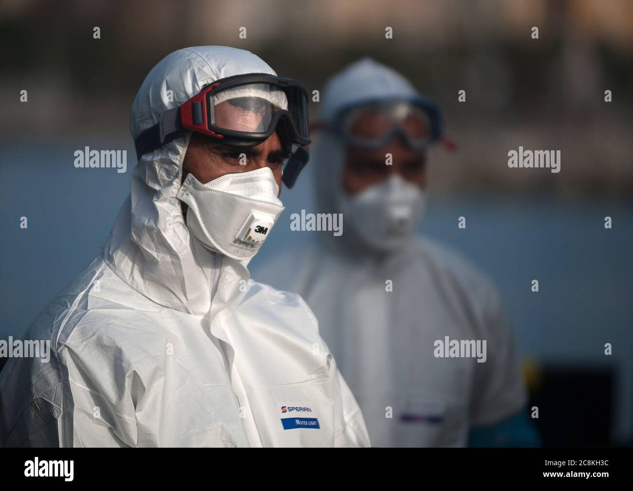 Members of European Border and Coast Guard Agency (Frontex) dressed in a protective suits on a patrol vessel at Malaga port after intercepted a dinghy on the Mediterranean Sea.A Spanish Civil Guard vessel intercepted around 82 Algerian migrants near Almeria's coast while trying to reach Europe by small boats. During the coronavirus pandemic, the closure of Morocco's border with Spain as a measure to prevent the spread of coronavirus disease has caused a drastic drop in the number of migrants that try to reach the Spanish coasts across Alboran Sea route, while the arrival of migrants to Canary Stock Photo