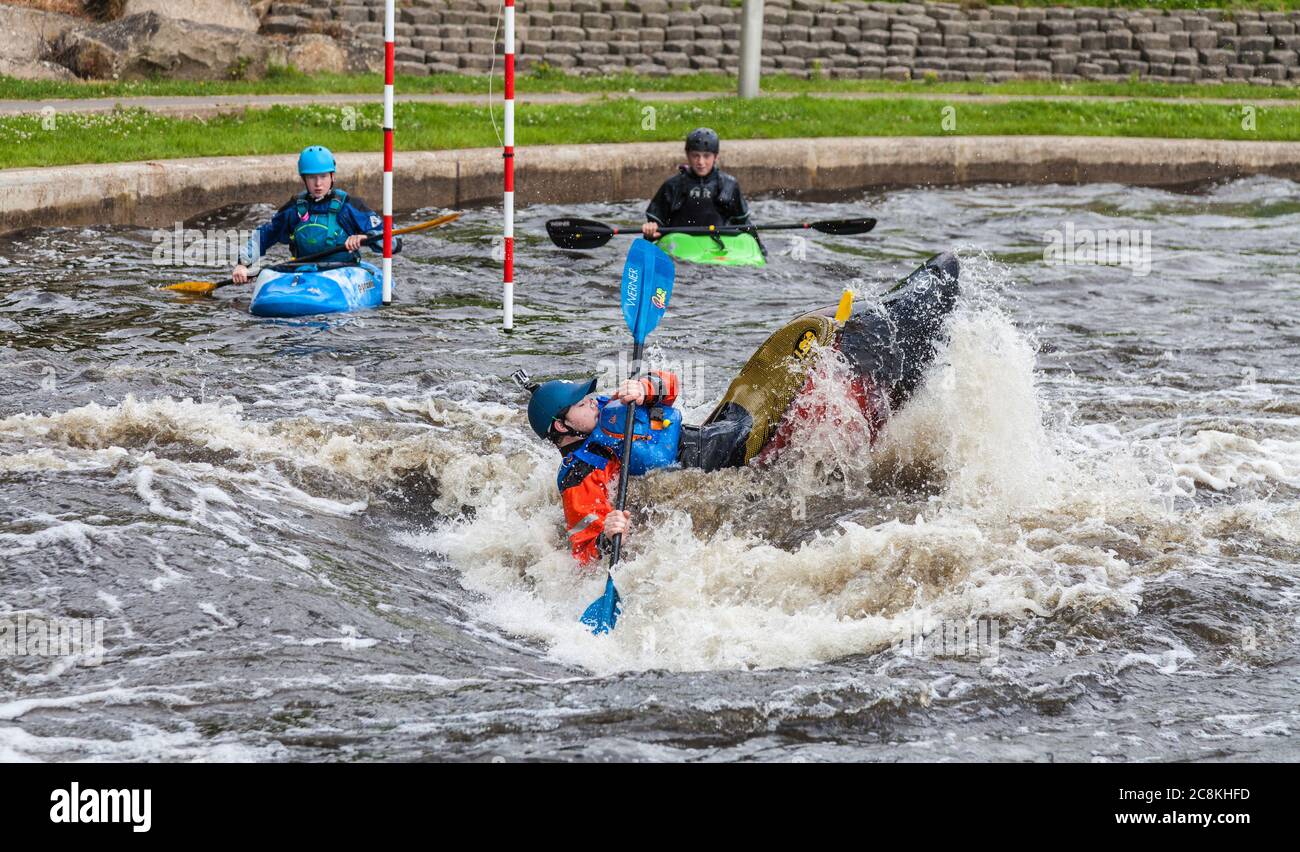 A man in a kayak performing an eskimo roll at the Tees Barrage