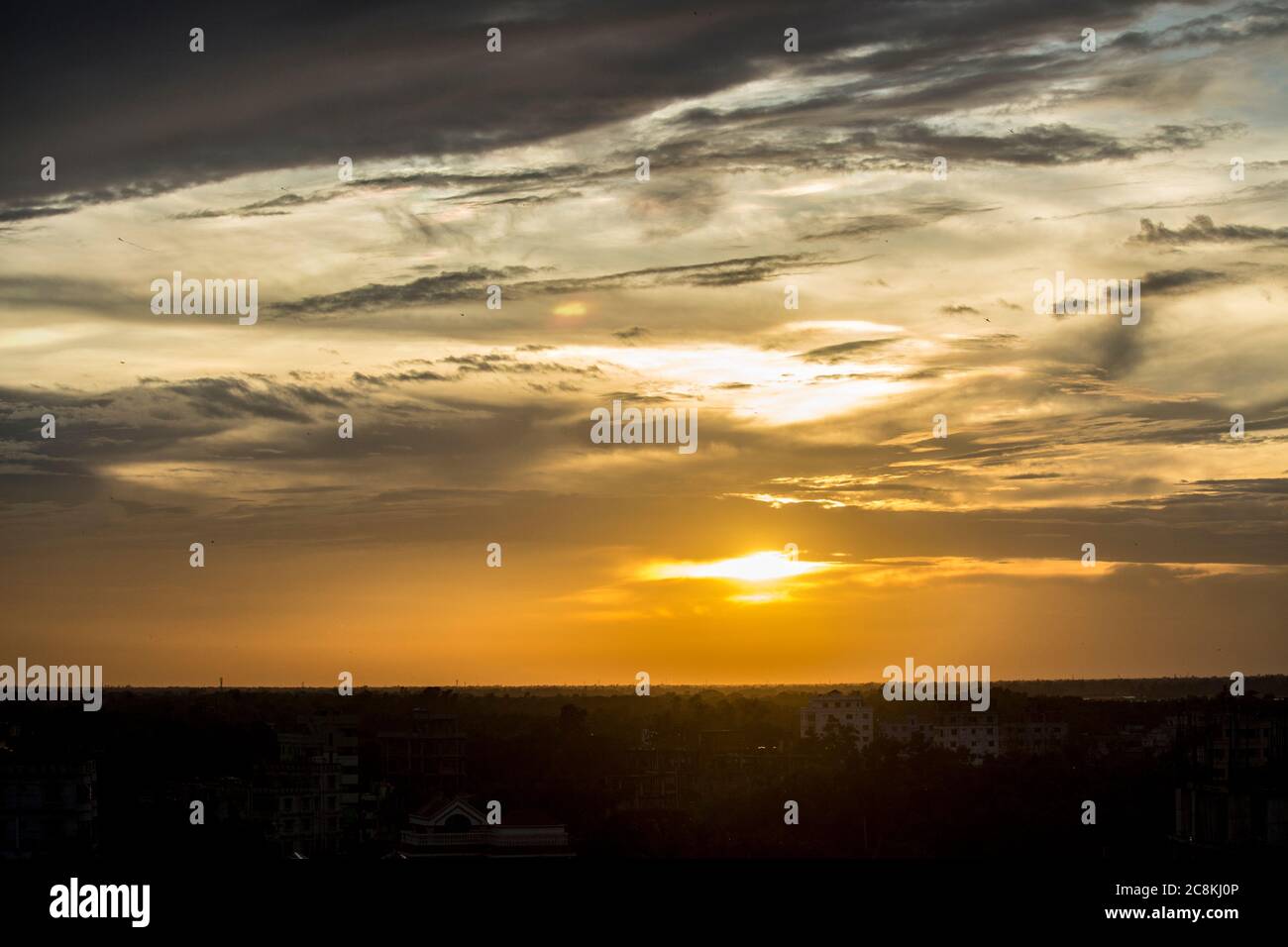 Scenic orange sunset sky background in Dhaka Stock Photo