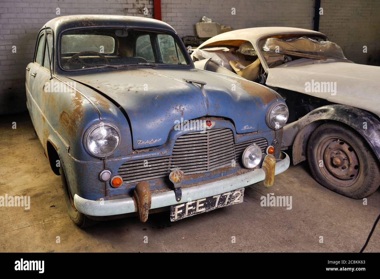 1950s Ford Zephyr Zodiac restoration project parked in a garage next to a Jensen 541 Stock Photo