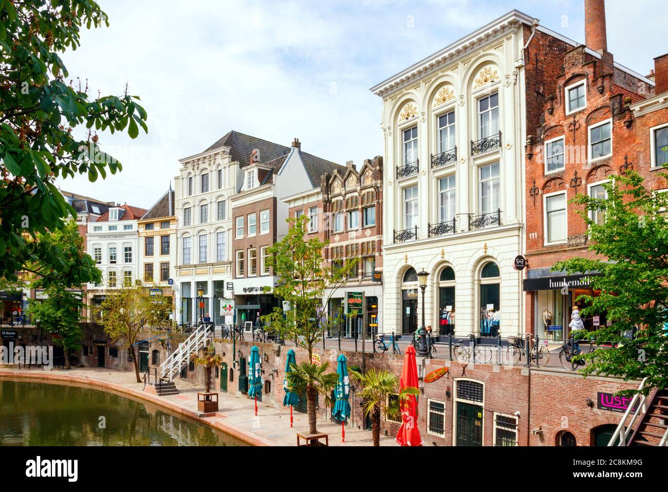 Utrecht city centre. Shops, monumental houses and medieval wharfs at the Oudegracht (Old Canal) on a sunny morning. The Netherlands. Stock Photo