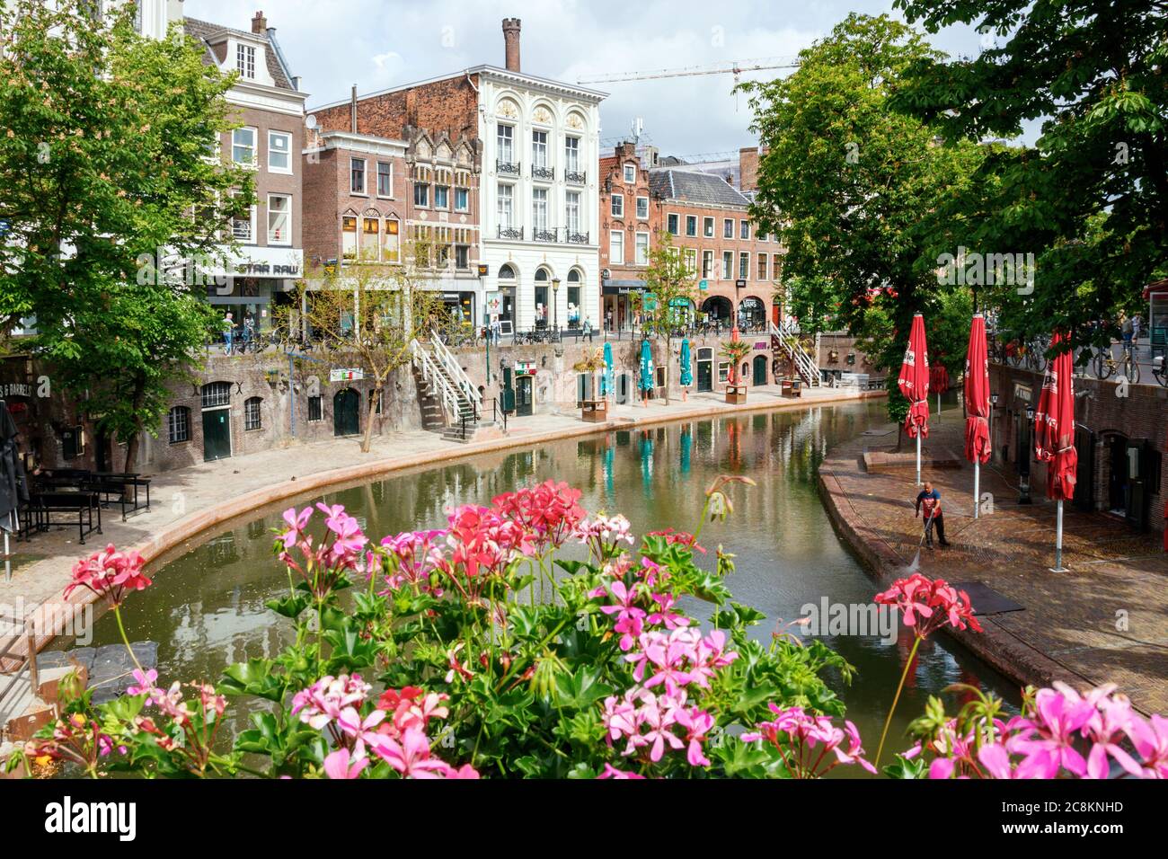 Utrecht. The Oudegracht (Old Canal) with flowers, medieval wharfs and the Fresenburch, one of the monumental houses. The Netherlands. Stock Photo