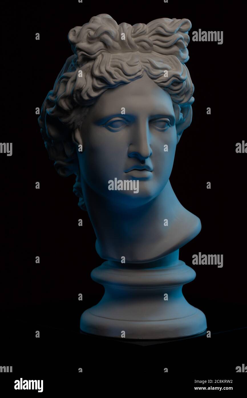 Plaster statue of a bust of Apollo Belvedere in blue local light on a
