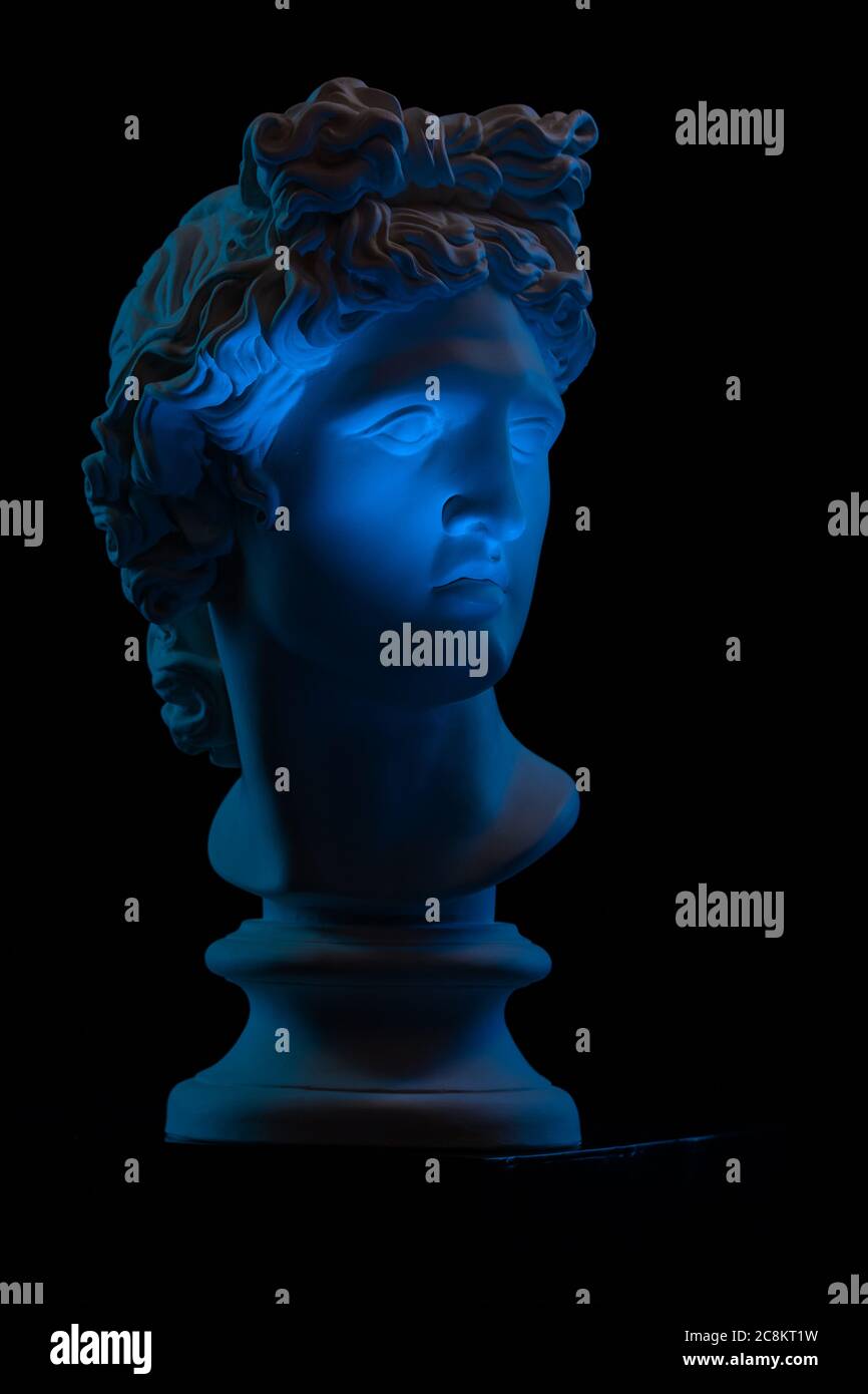 Plaster statue of a bust of Apollo Belvedere in blue local light on a
