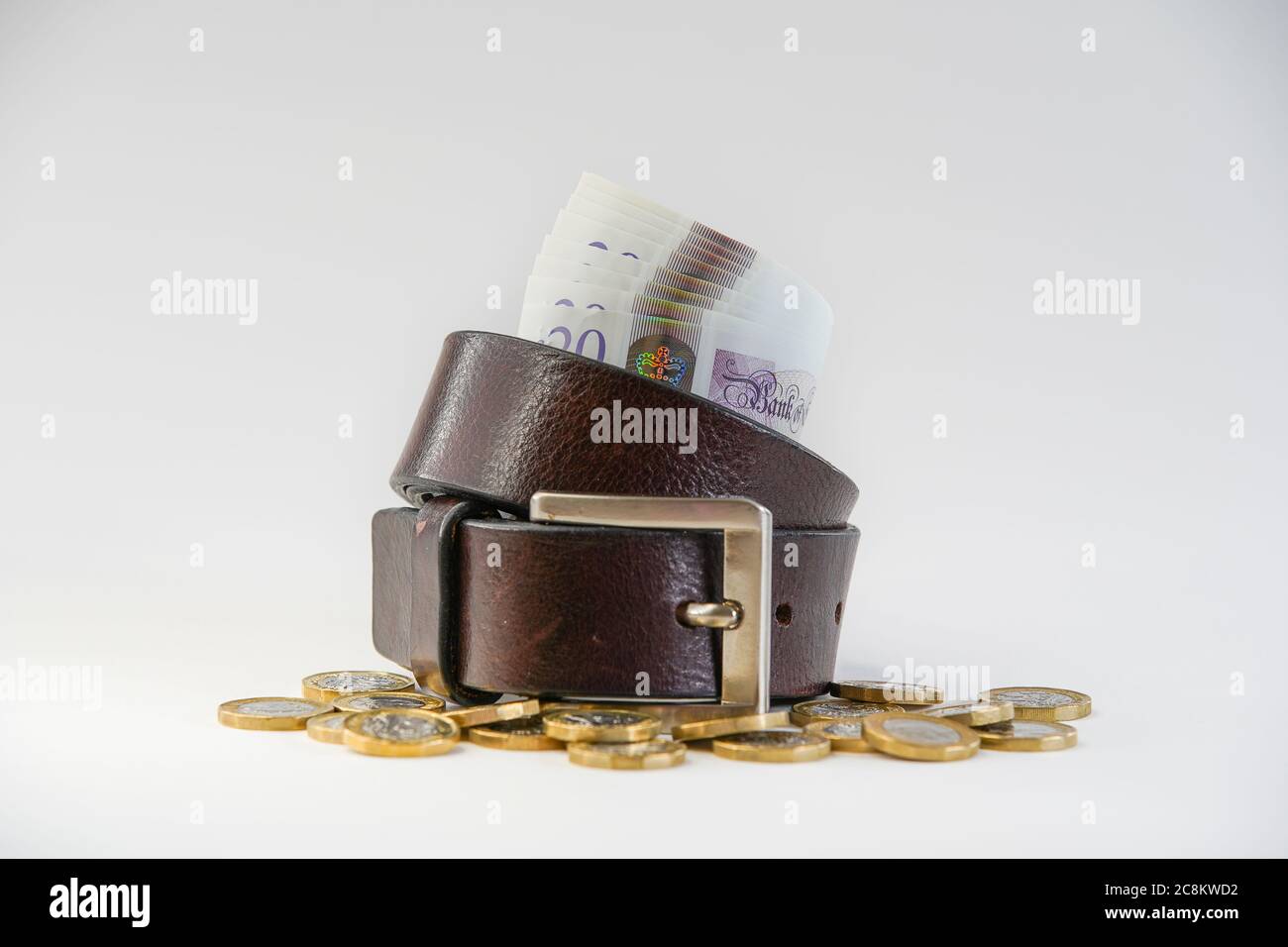Bundle of British ten pound notes inside a tightening belt on white