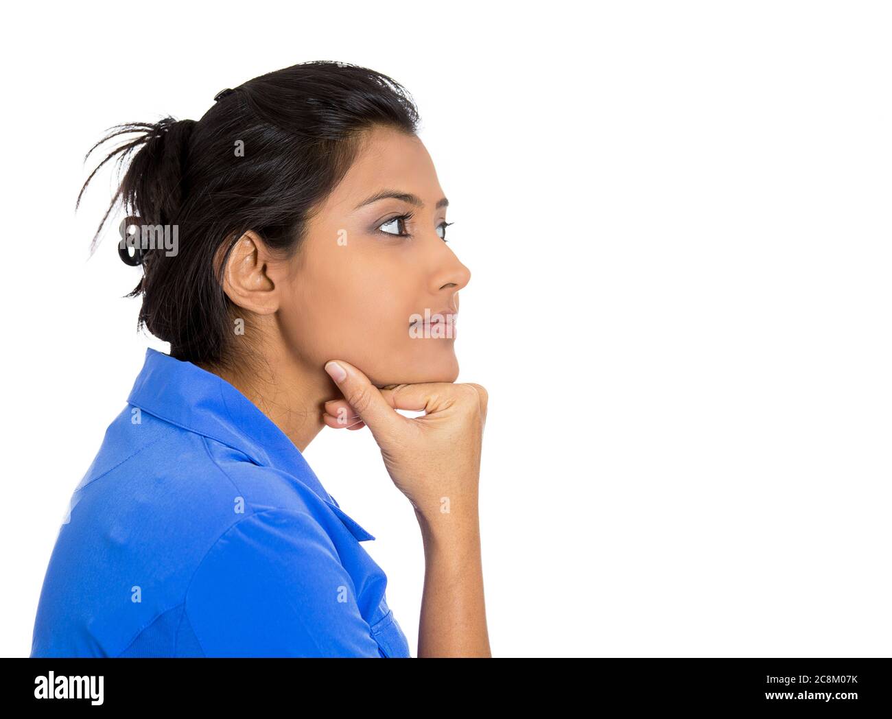 Side profile portrait of a young woman thinking daydreaming isolated on white background. Stock Photo