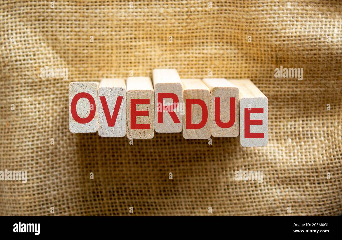 Wooden blocks form the word 'overdue' on beautiful canvas background ...