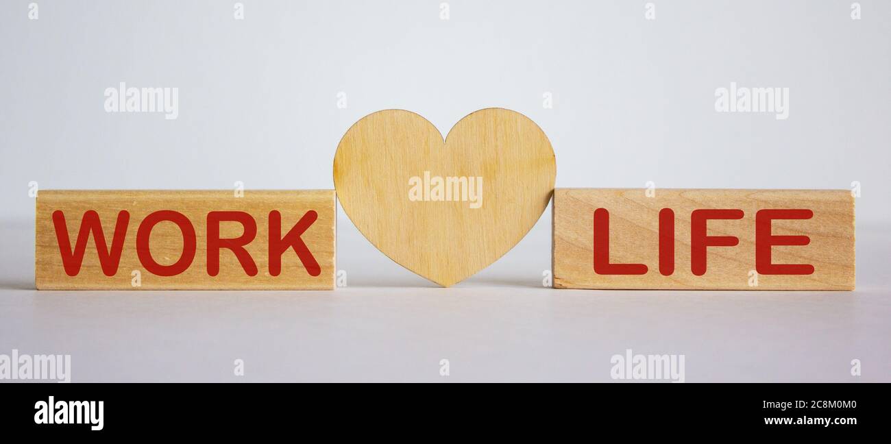 Wooden blocks with words 'work life' on white background. Wooden heart ...