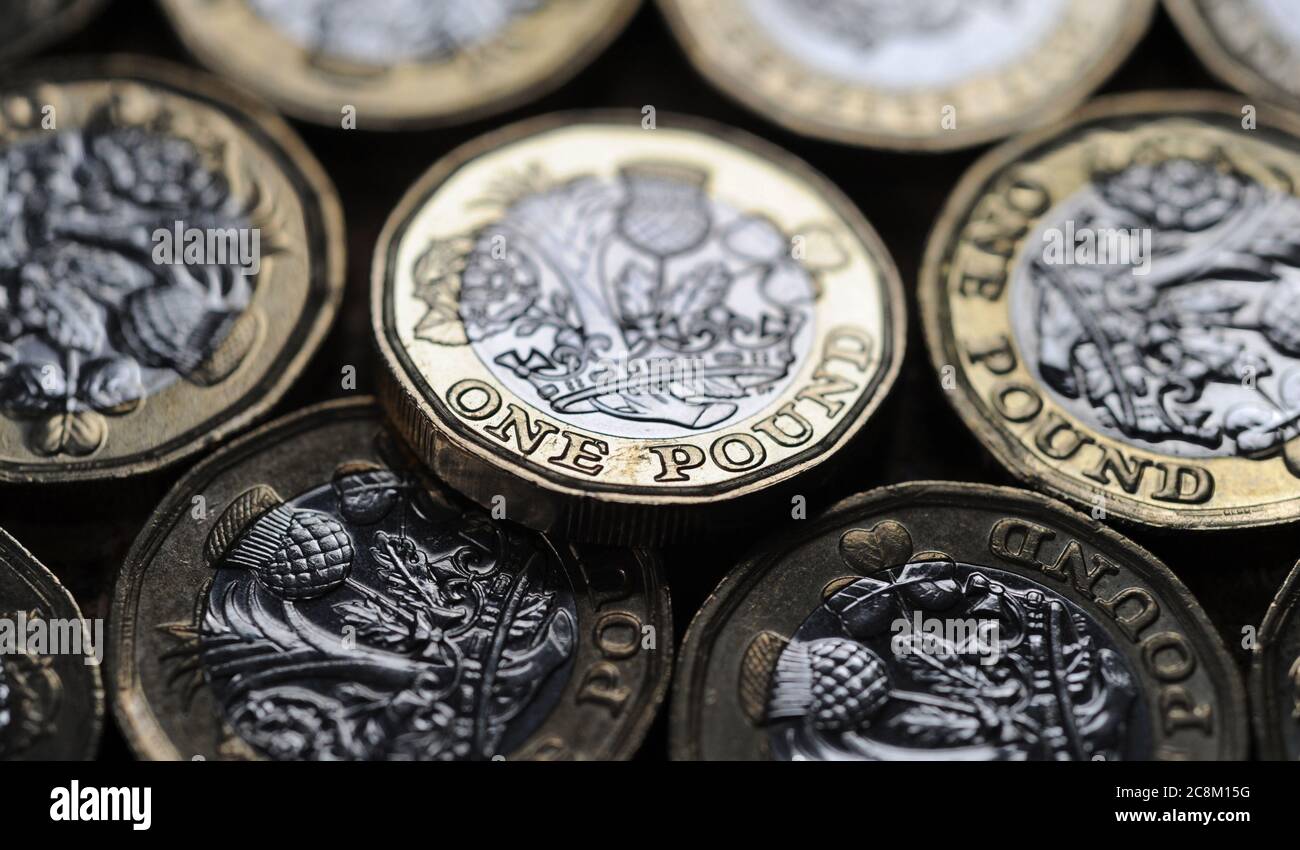 BRITISH ONE POUND COINS RE THE ECONOMY WAGES INTEREST RATES MORTGAGES INFLATION LENDING ETC UK Stock Photo