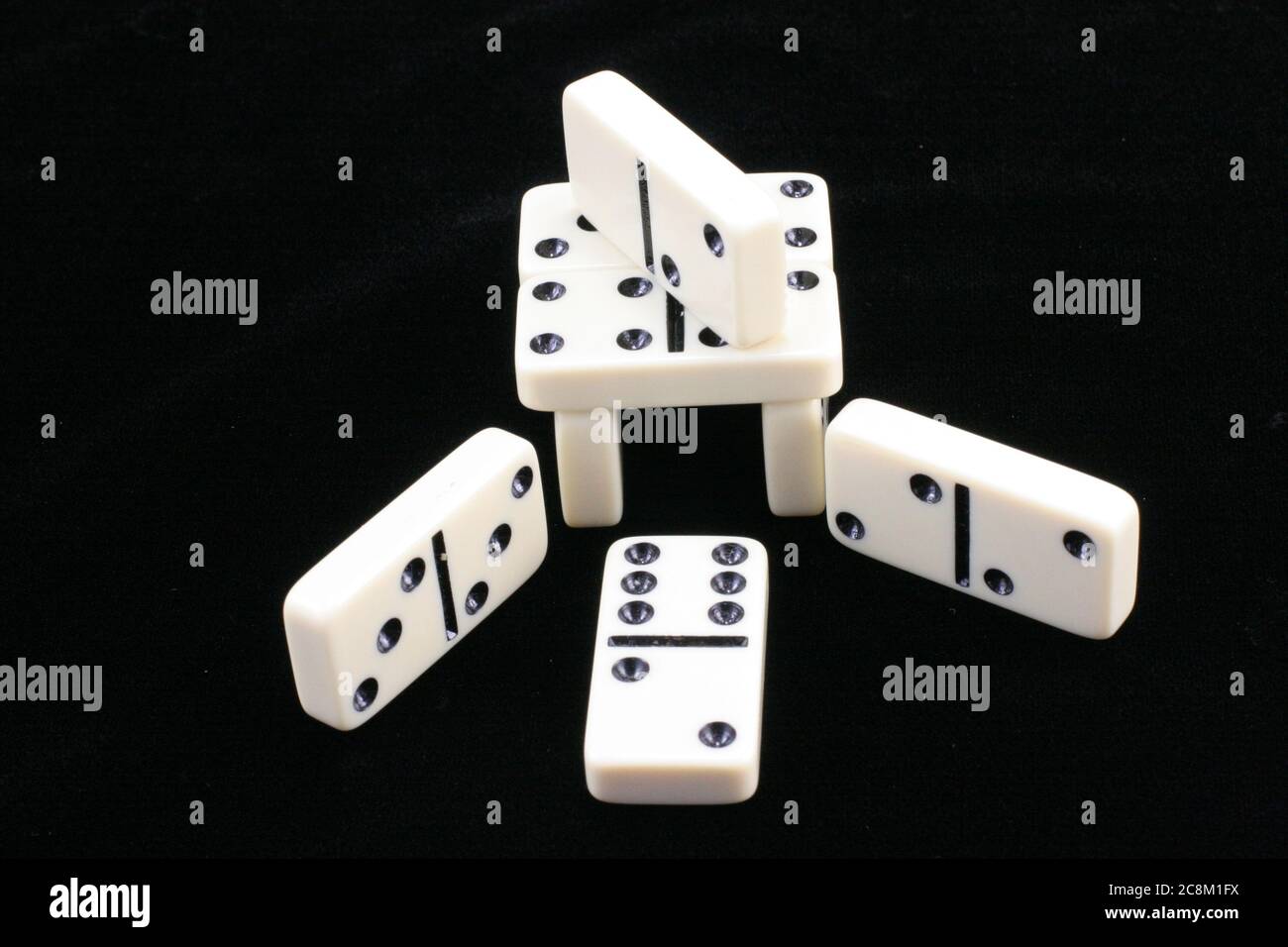 Game of white dominoes on a black background Stock Photo