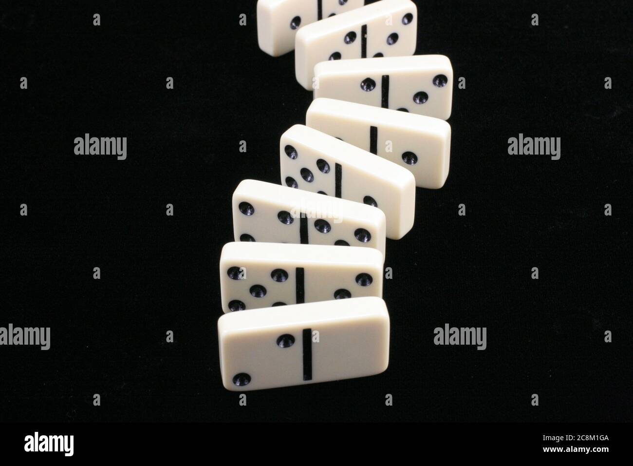 Game of white dominoes on a black background Stock Photo
