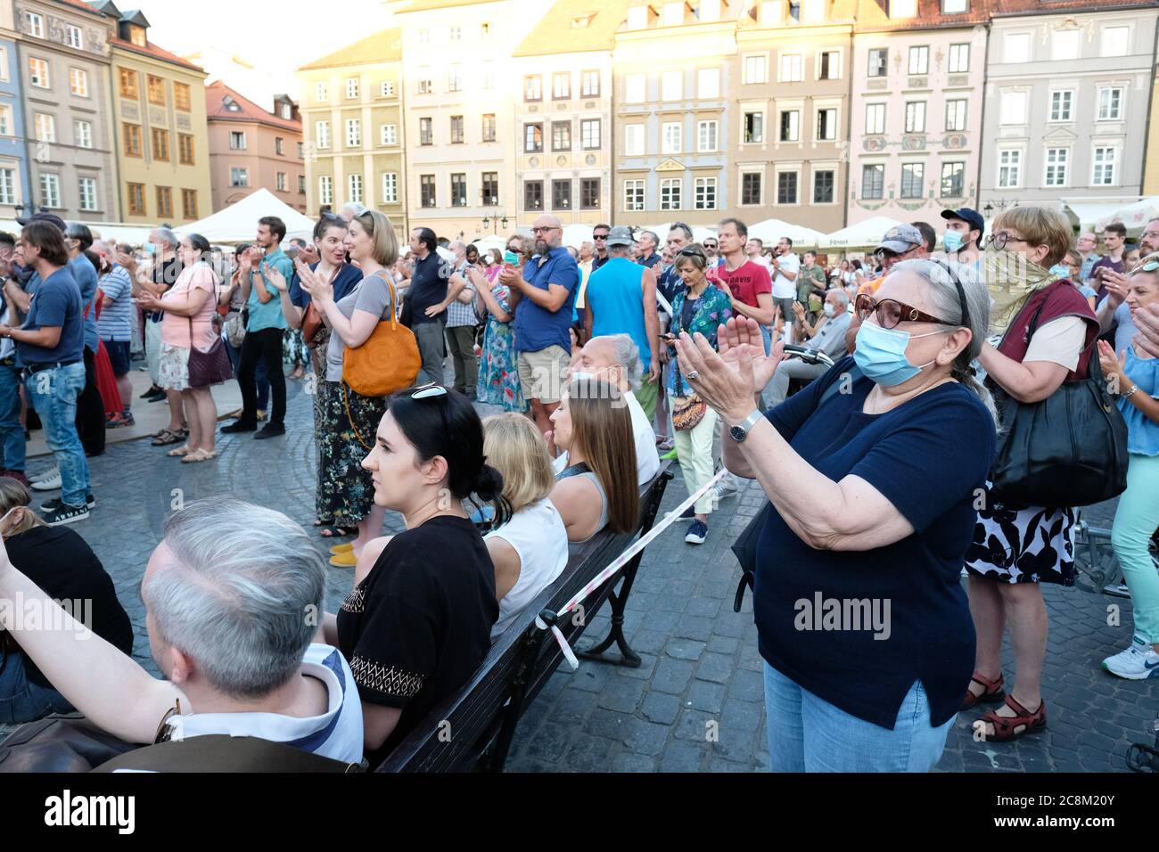 Warsaw, Poland - Saturday 25th July 2020 - A large crowd of locals and tourists enjoy an open air jazz concert in the Old Town area of Warsaw on a warm Saturday evening during the Coronavirus crisis, some wearing facemasks while trying to maintain social distancing as fears grow over a second wave of Covid across Europe. Photo Steven May / Alamy Live News Stock Photo