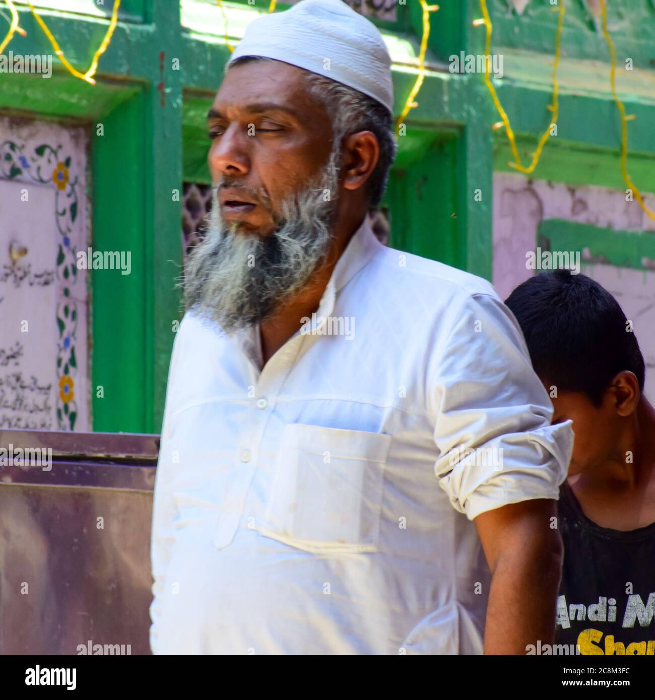 New Delhi India – March 13 2020 : Man Inside Hazrat Nizamuddin Dargah during the day time in Delhi India, Religious Darah of Nizamuddin in Delhi durin Stock Photo