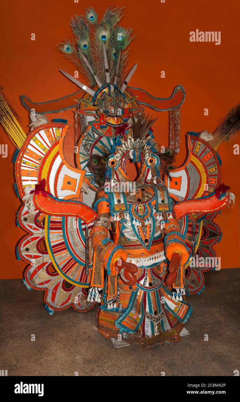 Nassau, the Bahamas - December 22, 2011 - An elaborate bright orange festival costume with peacock feathers. Stock Photo