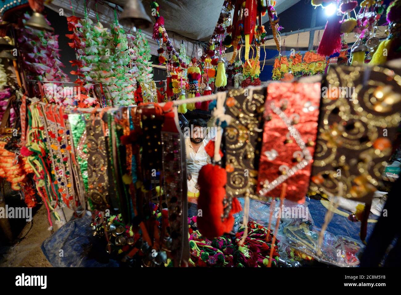 Islamabad, Pakistan. 25th July, 2020. A man sells decorations for