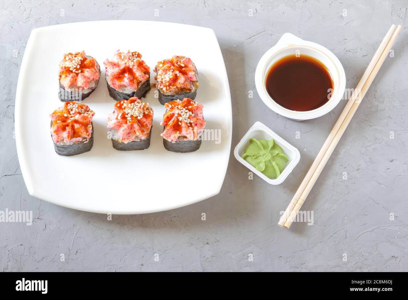 Japanese sushi with soy sauce and wasabi with chopsticks on a grey concrete background. Top view Stock Photo