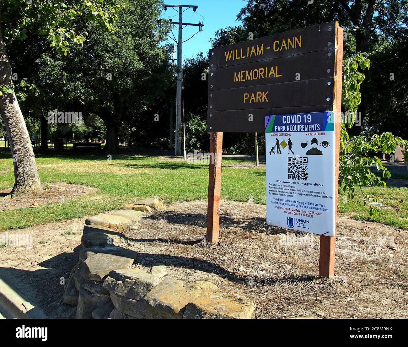 Covid 19 Park requirements sign at entrance to William  Cann Park in Union City, California Stock Photo