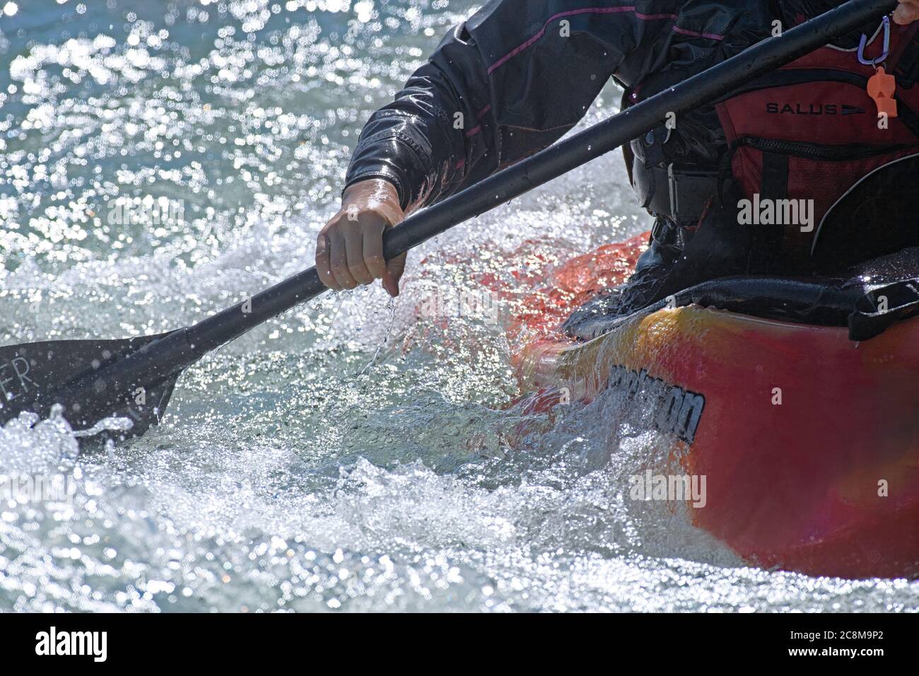 White water kayaker kayaking on the Bow River in Calgary Alberta Canada