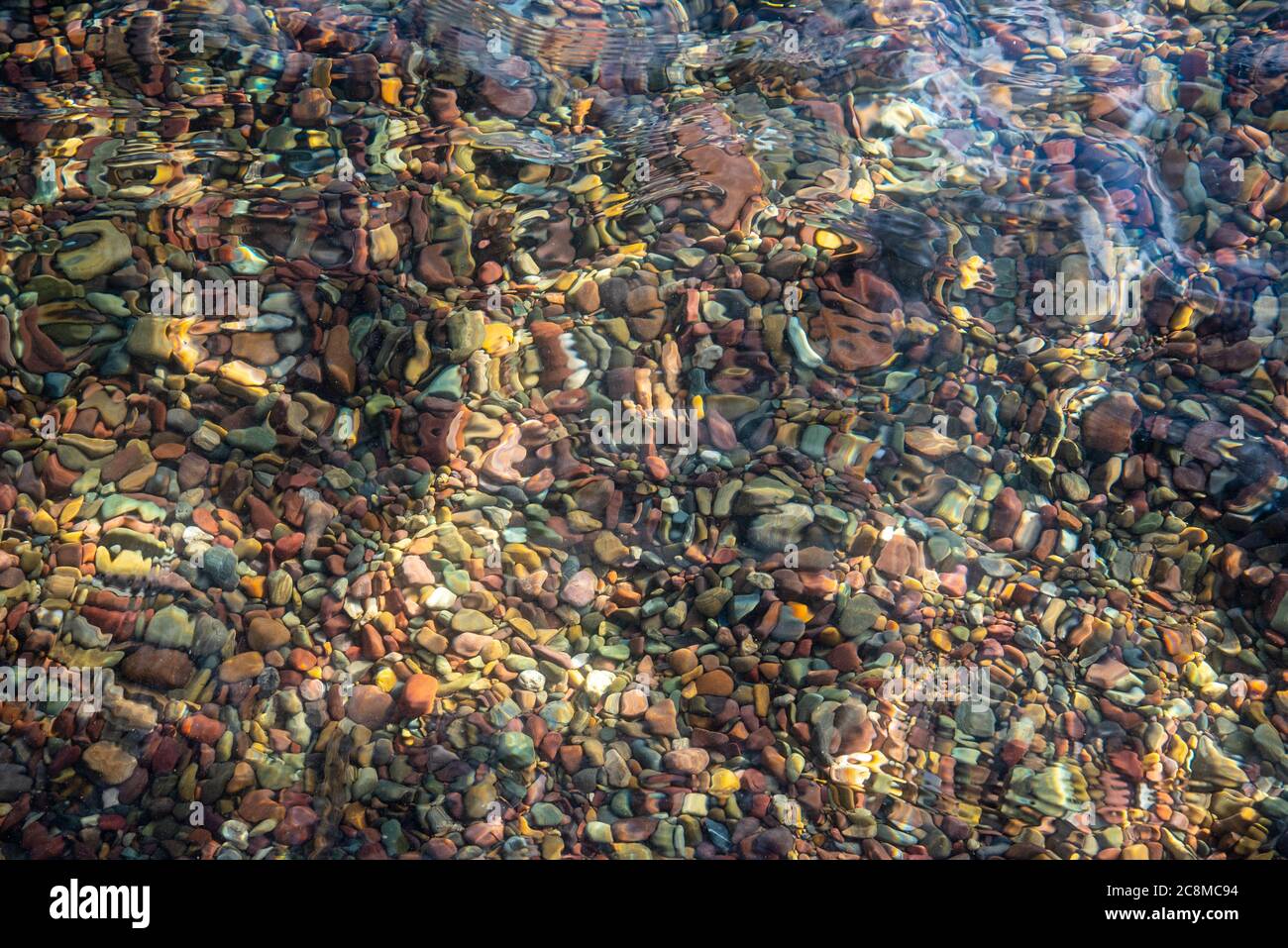 Colorful stones in Lake McDonald Stock Photo