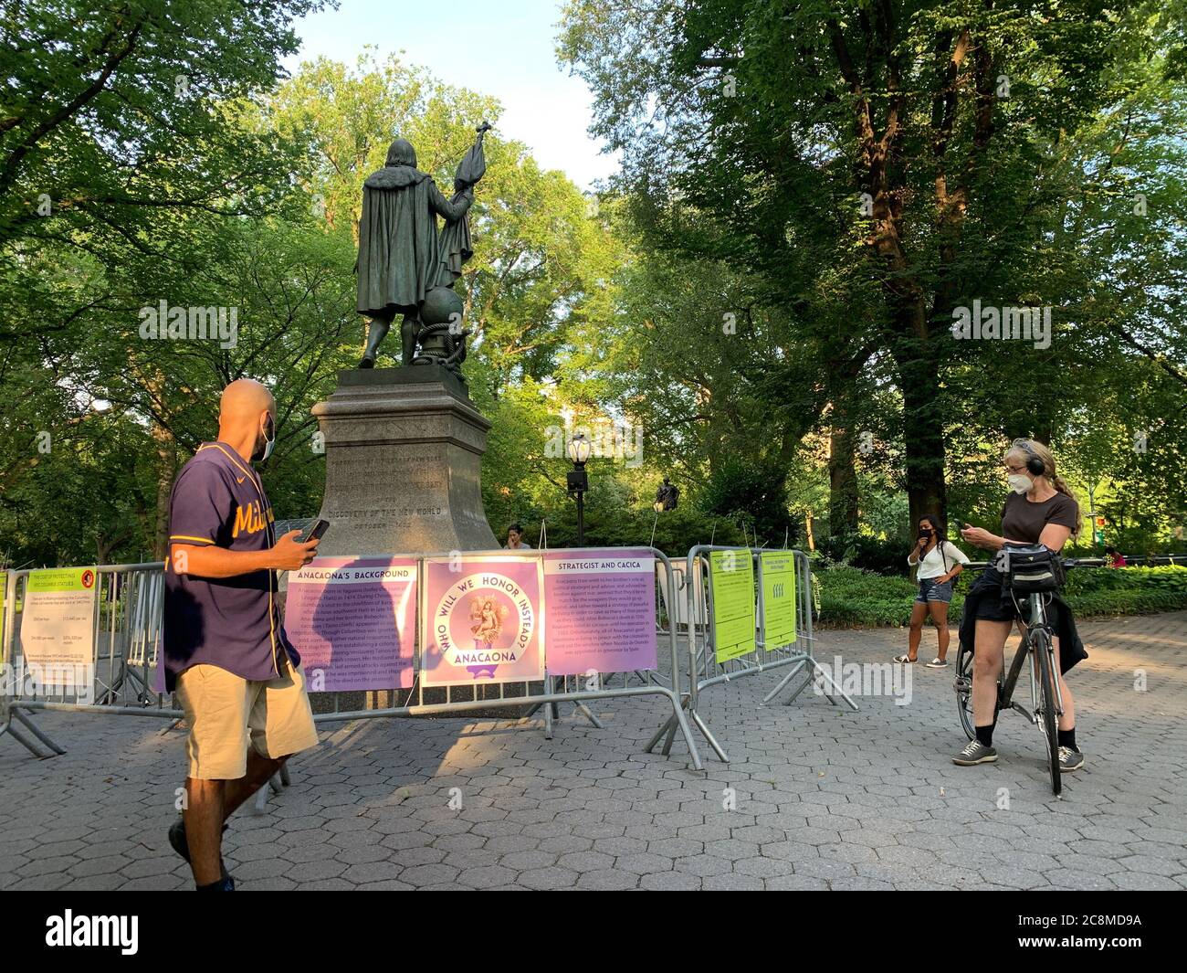 July 25, 2020, New York, USA: (NEW) Protest Ã¢â‚¬Å“Take down Columbus.Ã¢â‚¬Â July 25, 2020, New York, USA: A group of protesters called Ã¢â‚¬Å“Take Down Columbus NYCÃ¢â‚¬Â gathered at Central Park to demand the taking down of Christopher ColumbusÃ¢â‚¬â„¢ statue which has been under protection of NYPD policemen for some time now . The statue is also barricaded with fences to prevent its destruction by protesters. The protesters demand instead the Columbus replacement with ANACAONA, who was a composer of ballads, narrative poems and traditional dances called AREITOS and who was captured and la Stock Photo