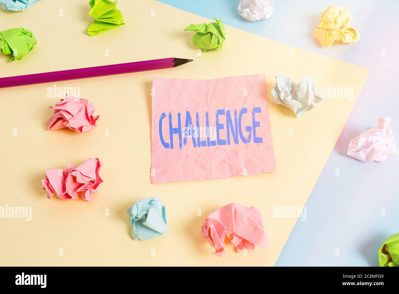 Conceptual hand writing showing Challenge. Concept meaning process of provoking or testing physiological activity by exposure Colored crumpled papers Stock Photo